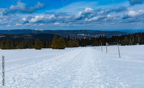 Snowy landscape of mountain trails and hills at cloudy morning