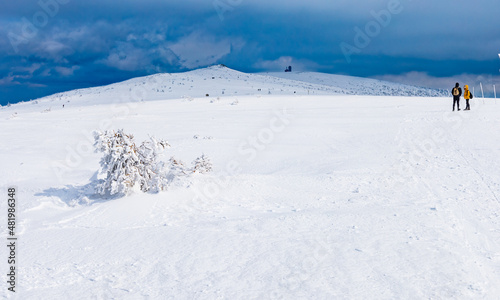 Snowy landscape of mountain trails and hills at cloudy morning