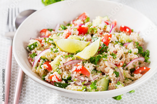 Tabbouleh salad. Traditional middle eastern or arab dish. Levantine vegetarian salad with parsley, cucumber, couscous, tomato.