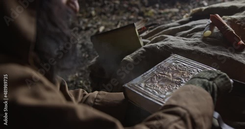 Crop wiseman opening old book