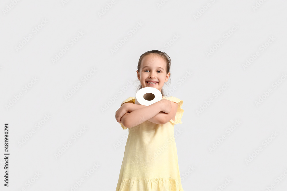 Smiling little girl with toilet paper on light background Smiling little girl with toilet paper on light background