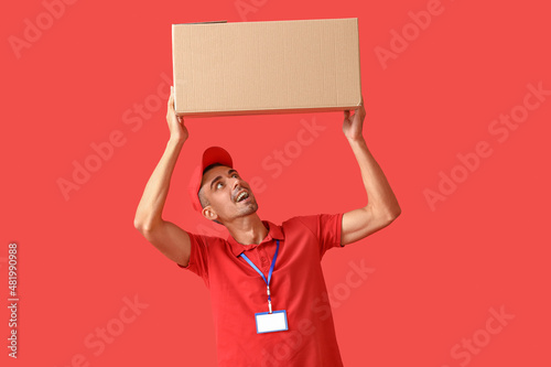 Male courier with parcel on...