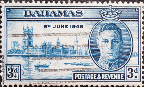 Bahamas - circa 1946 : a postage stamp from Bahamas, showing the portrait of King George VI and Houses of Parliament, London