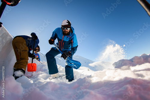 Fotografia, Obraz men with shovels digging the snow