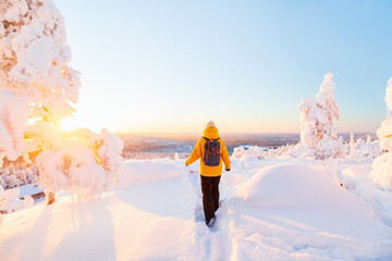 Young woman in winter forest in Finland