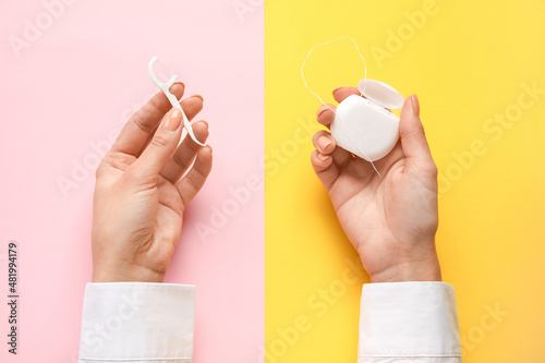 Woman with dental floss and toothpick on color background photo