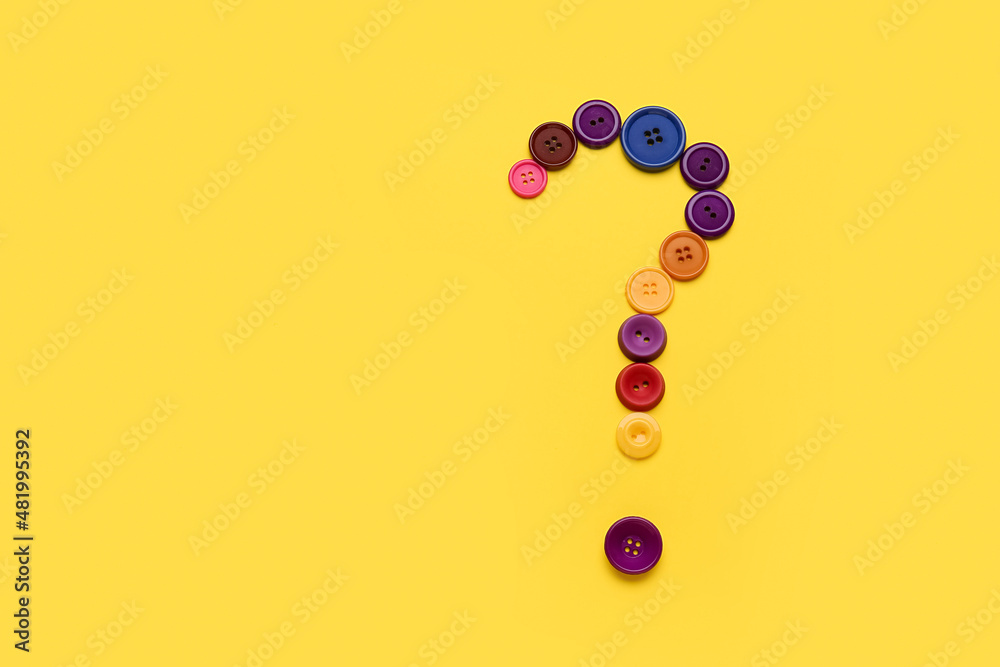 Question mark made of buttons on yellow background Question mark made of buttons on yellow background