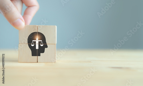 Business ethics concept. Ethics inside human mind. Business integrity and moral. The wooden cubes with ethics inside a head symbols on grey background and copy space. Company ethics culture. ESG. photo