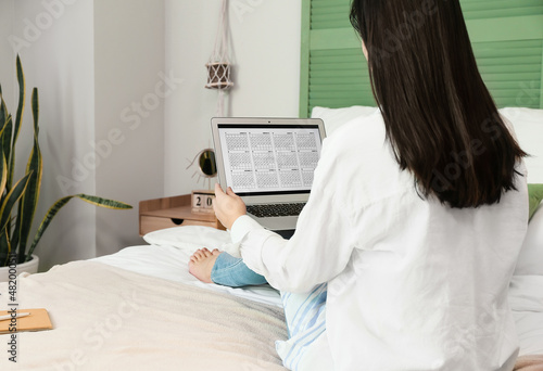 Woman using calendar on lap...