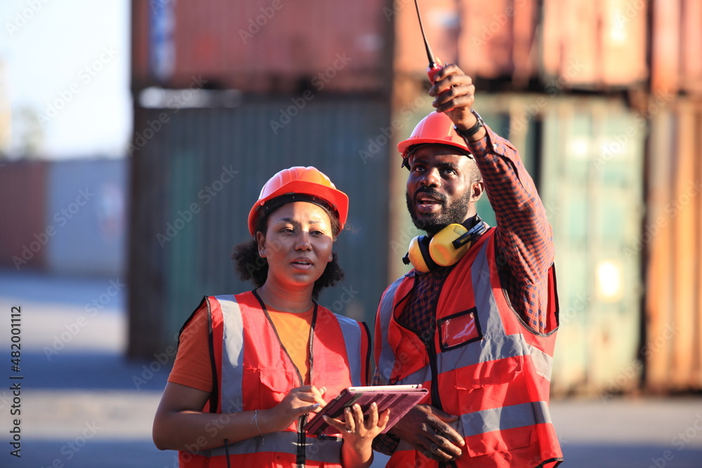 African American black engineer they are working in container box yard area of logistics transportation import export or shipping industry