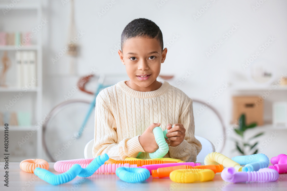 Little African-American boy playing with Pop Tubes at home Little African-American boy playing with Pop Tubes at home