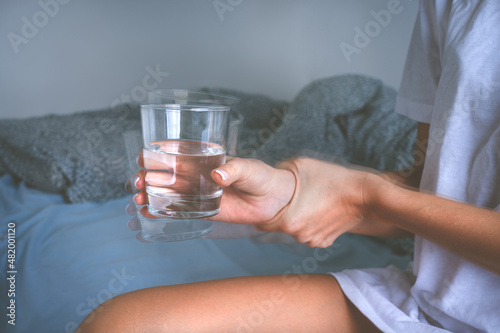 Tremor or shaking hands. Woman with shaky hands suffering from Parkinson's disease symptoms or essential tremor.