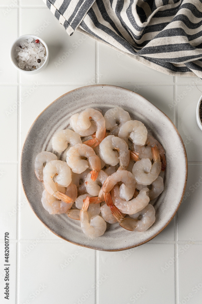 Thawed peeled shrimp, seafood, delicacy. on a white background, in a dish. beautiful product presentation Thawed peeled shrimp, seafood, delicacy. on a white background, in a dish. beautiful product presentation