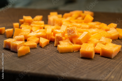 Fresh carrot on a light wooden table.