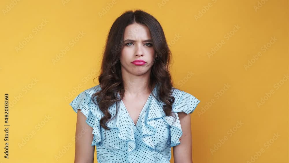 Silly meme woman. Protesting expression. Displeased situation. Dissatisfied lady shaking head expressing disagreement isolated orange looped video. Silly meme woman. Protesting expression. Displeased situation. Dissatisfied lady shaking head expressing disagreement isolated orange looped video.