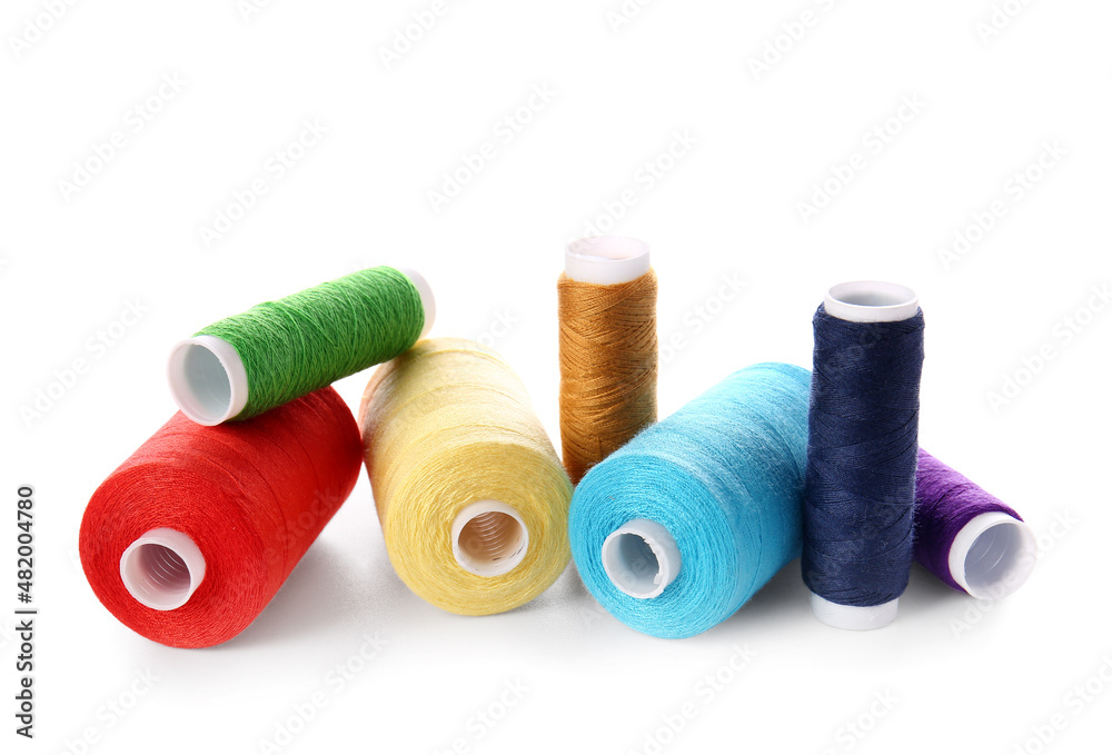 Different sewing thread spools on white background Different sewing thread spools on white background