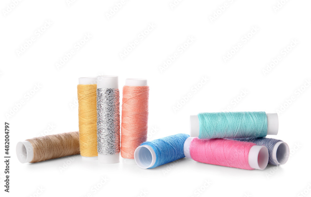 Different sewing thread spools on white background Different sewing thread spools on white background