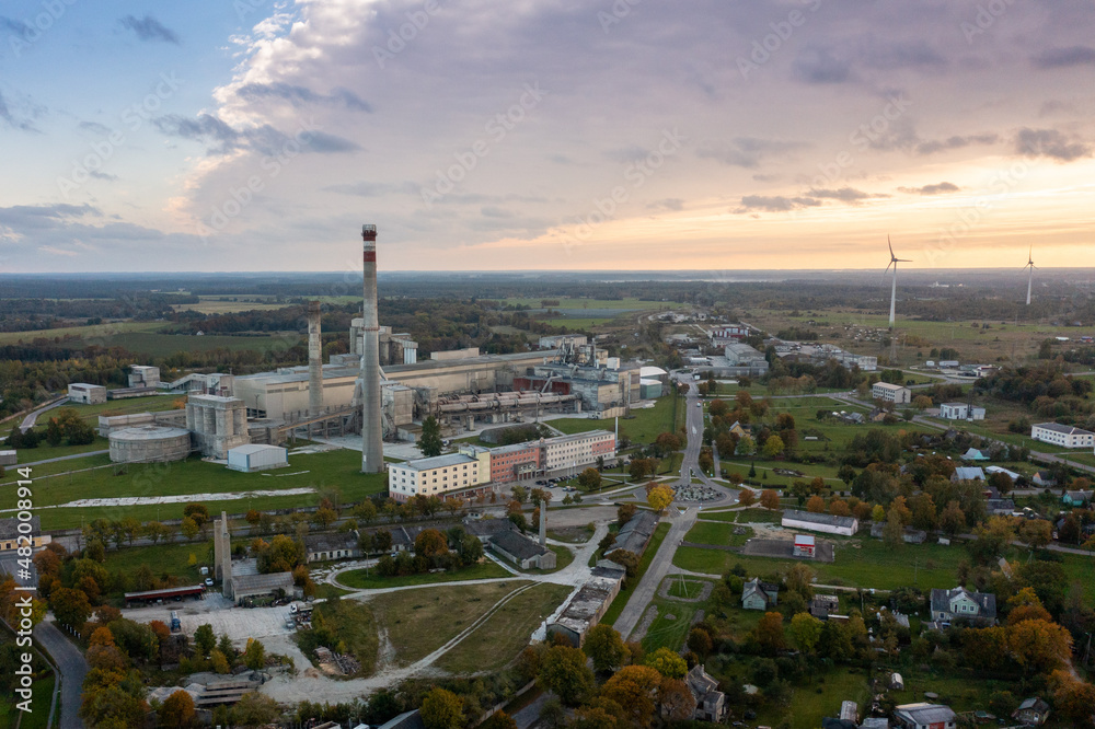 An aerial drone view of the industrial city in the Baltic. Plant for the production of concrete. Wind park.