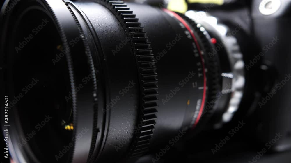 Long-focus lens with rotating manual focus. Mounted on the camera lens on a black background. Long-focus lens with rotating manual focus. Mounted on the camera lens on a black background.