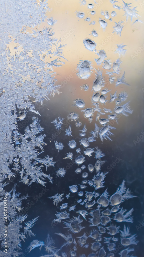 Ice drops and frost on the window pane