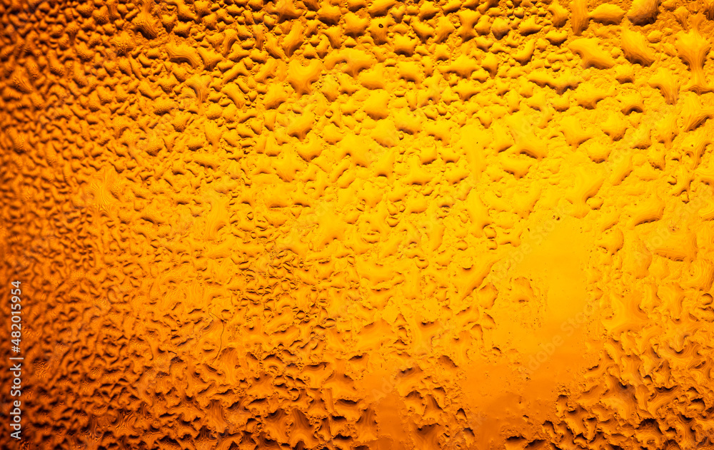 macro beer drink,Water drops background,Close up drops of a Ice Cold Pint of Beer- condensation. The background is clear with the emphasis on water drops on yellow-golden background. macro beer drink,Water drops background,Close up drops of a Ice Cold Pint of Beer- condensation. The background is clear with the emphasis on water drops on yellow-golden background.