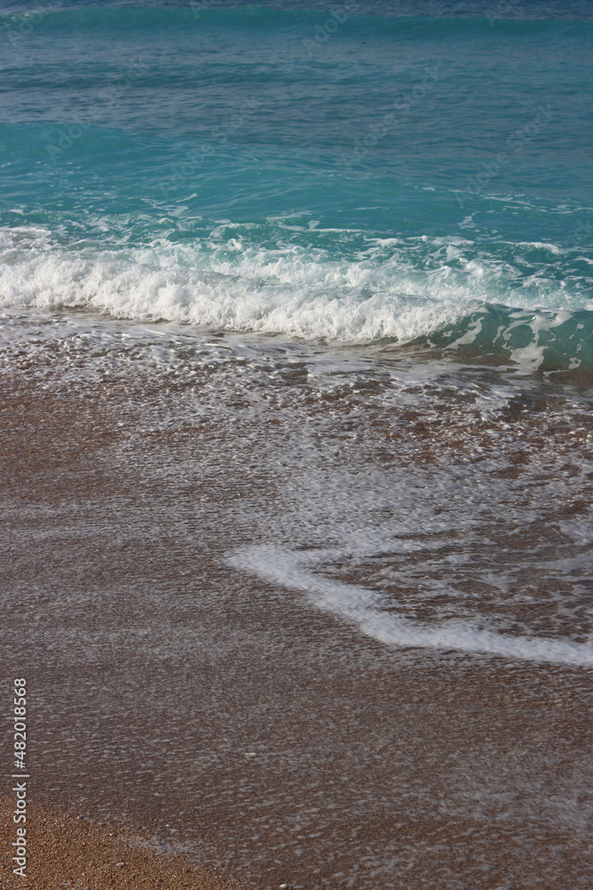 Clear blue sea water close up photo. Calm sea, blue sky,  tranquil scene. Warm day on the beach. 