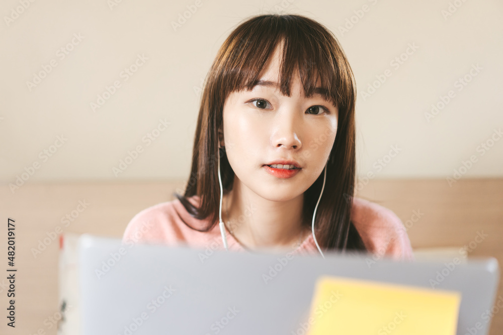 Young adult asian woman in bedroom use laptop computer for work and education online. Young adult asian woman in bedroom use laptop computer for work and education online.