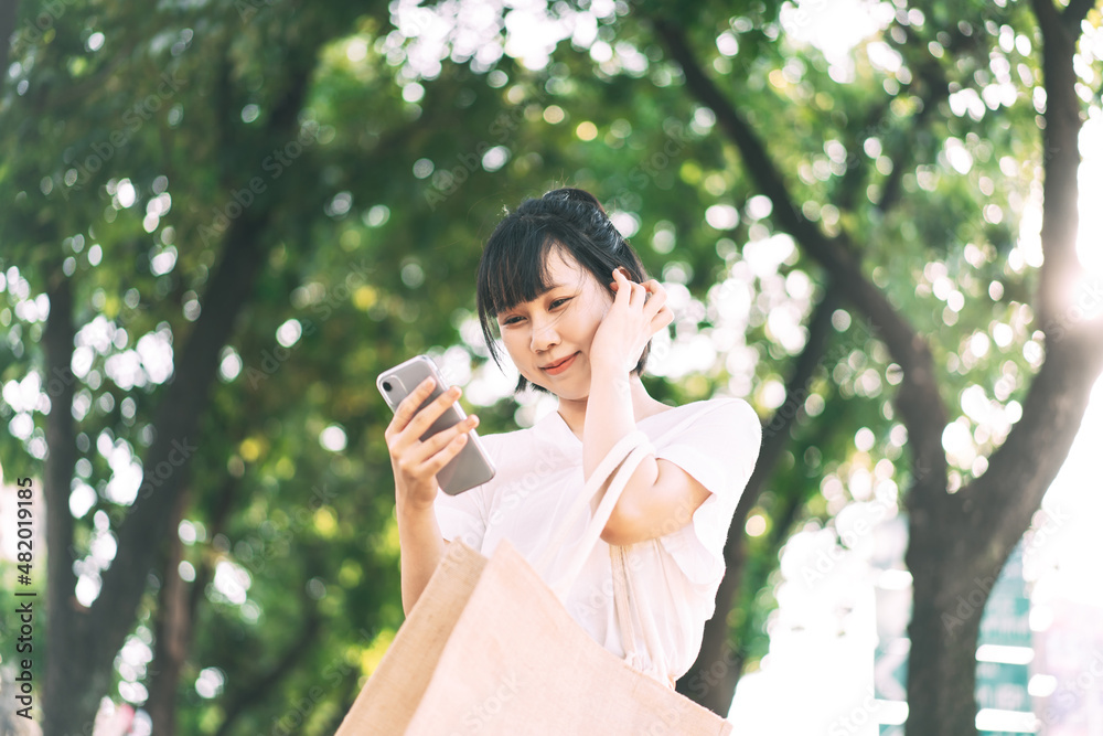 Young adult asian business single woman using mobile phone for dating application. Young adult asian business single woman using mobile phone for dating application.