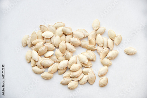 Pumpkin seeds on a white background close-up