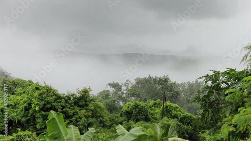 Time lapse view of moving mists through the valley between the hills