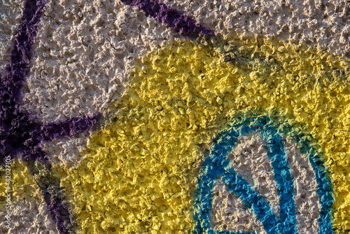 Old colorful concrete wall plastered with traces of old paint, texture.