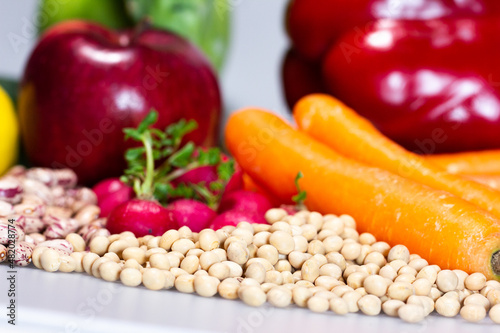 vegan food: soy with carrots, apple, radish, broccoli, bell pepper