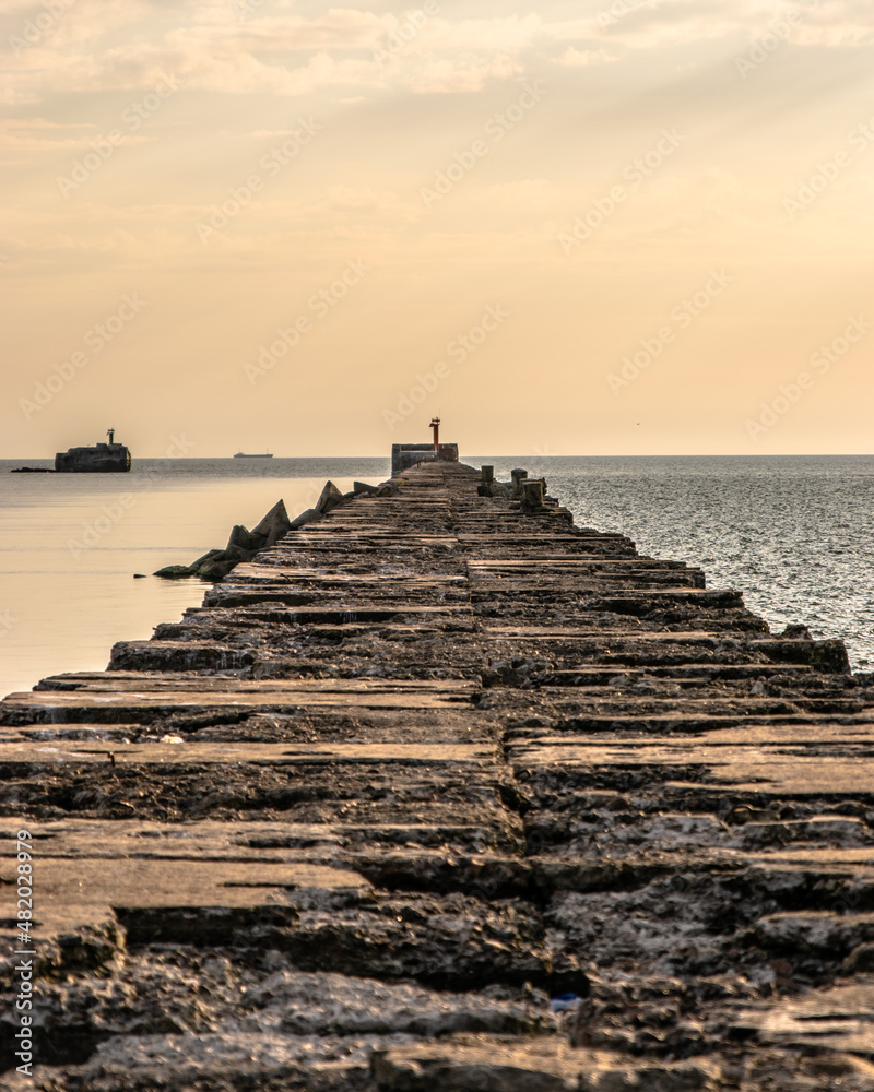 Old stone pier in the sea at the evening