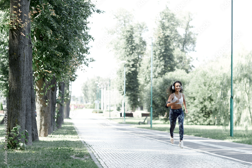 Latina afro beautiful woman runner. She was running on the road in the morning. Latina afro beautiful woman runner. She was running on the road in the morning.