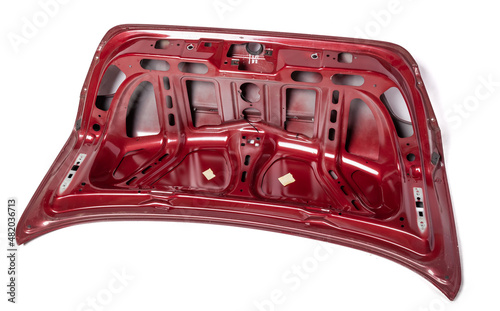 Red metallic boot lid reverse side with stiffeners on a white isolated background in a photo studio with a nameplate for installation on a car after an accident. Spare part for body repair photo