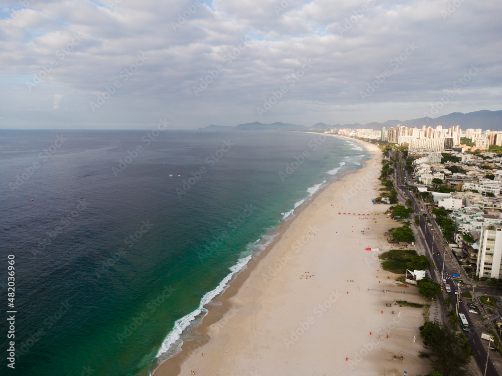 Aerial view of Barra da Tijuca Beach in the west side of Rio de Janeiro, Brazil. Sunny day with some clouds at dawn. Drone Photo