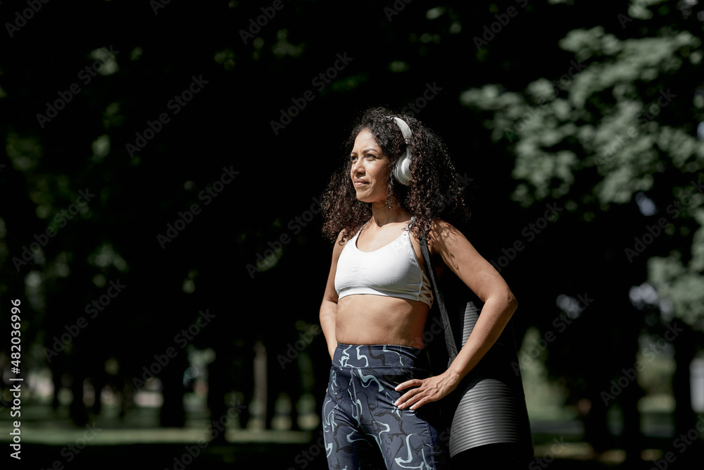 Beautiful african american latina girl doing physical exercises in the summer in the park. The concept of a healthy lifestyle.