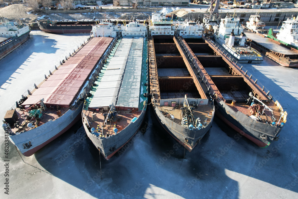 Cargo transportation. a lot of old bulk carriers. View from the nose. Winter layup of ships at the mouth of the Volga River in Volgograd. Russia