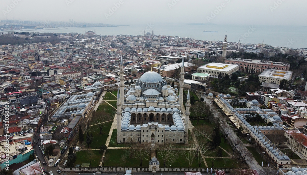 Aerial view of Suleymaniye mosque backgrounded by the Bosphorus strait during a snowy winter morning in Istanbul, Turkey.