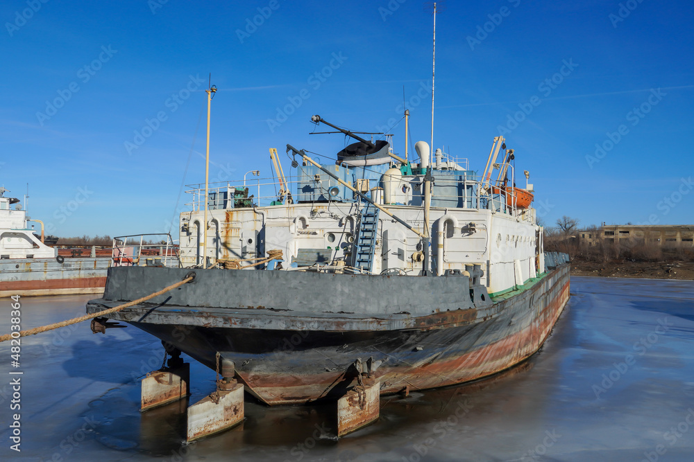 Cargo transportation. Old cargo ship. Winter layup of ships at the mouth of the Volga River in Volgograd. Russia