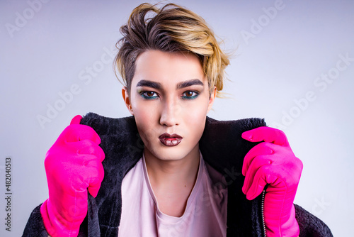Portrait of stylish fashion man confident and self-acceptance with his gender identity in studio white background