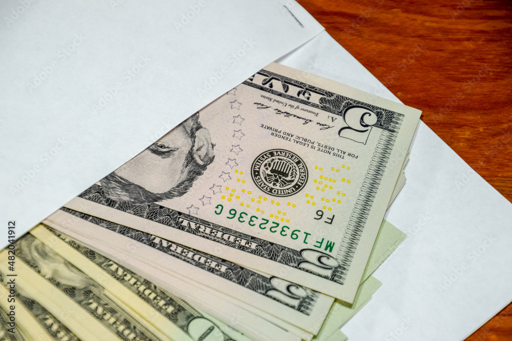 Dollars on table with an envelope. Money in an envelope. U.S. dollars. Dollars on table with an envelope. Money in an envelope. U.S. dollars.