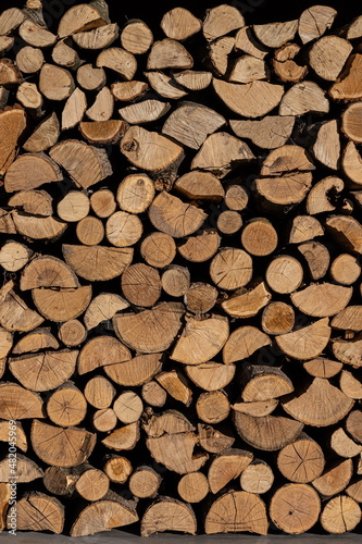 Pile of stacked triangle firewood prepared for fireplace and boiler