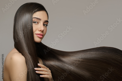 Murais de parede Fashion woman with straight long shiny hair. Beauty and hair care