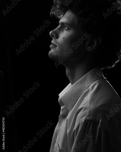 Caucasian man looking up portrait in white shirt in black and white