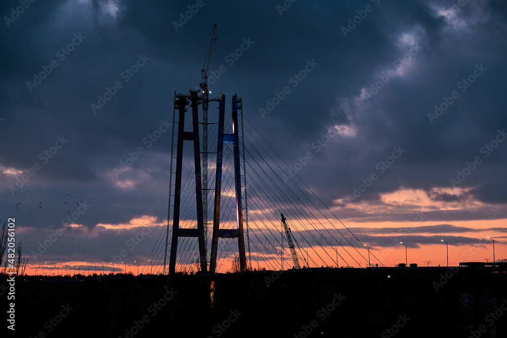 High pylons of a cable-stayed bridge in Zaporozhye, Ukraine. Sunset.