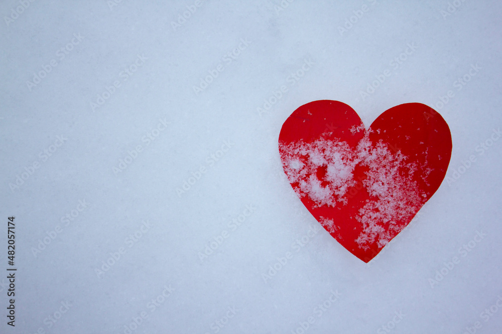 red heart made of paper, valentine in the snow
