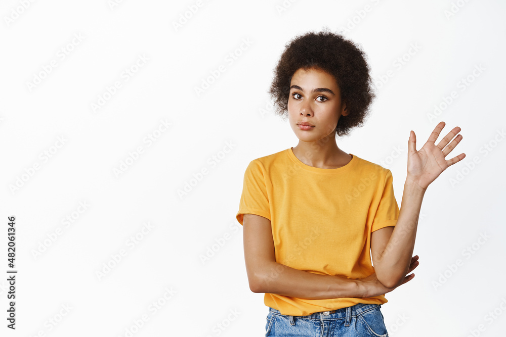 Young reluctant african girl wave away with unamused, bored face expression, unwilling to listen, rejecting smth boring, standing over white background Young reluctant african girl wave away with unamused, bored face expression, unwilling to listen, rejecting smth boring, standing over white background