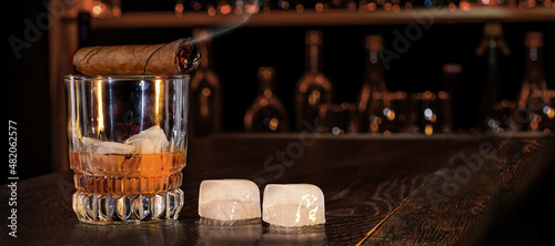 Canvas Print Cigar, elegant glass of brandy on the bar counter