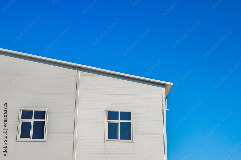 White warehouse blue sky on background